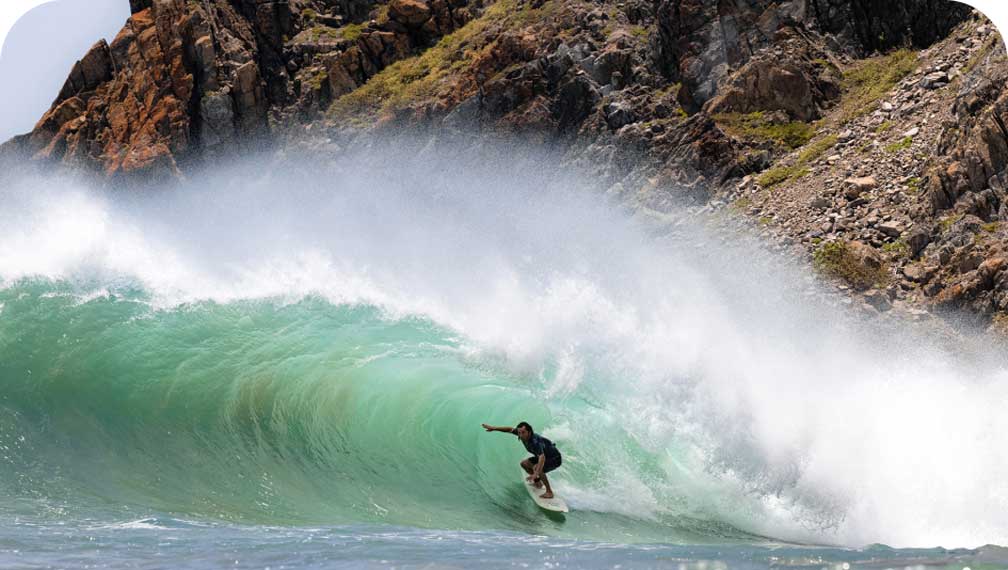 A surfer rides deep in the tube.