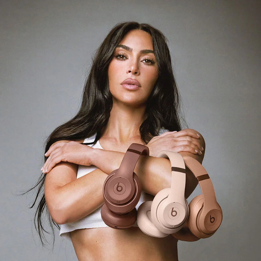 Kim Kardashian holding her Beats Studio Pro headphones in Moon, Dune and Earth.