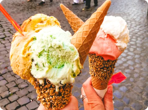 Image Description: Two people holding ice cream cones.