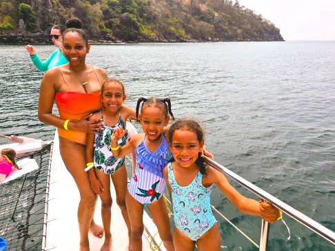 Image Description: Four people posing on a boat.
