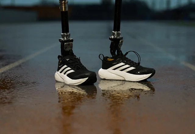 Person with prosthetics wearing Supernova Adapt shoes