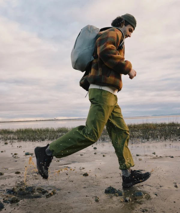 Graphic of a man walking through mud with his Stormburst Low Tops in Black.