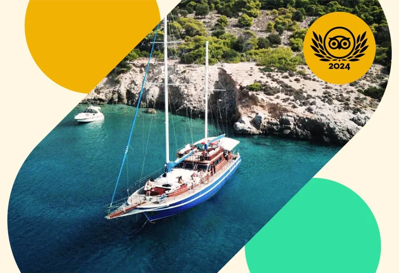 Image Description: Aerial view of a large yacht floating on turquoise waters beside a rocky cliff, overlaid with a gold 2024 Travelers’ Choice Awards Best of the Best badge