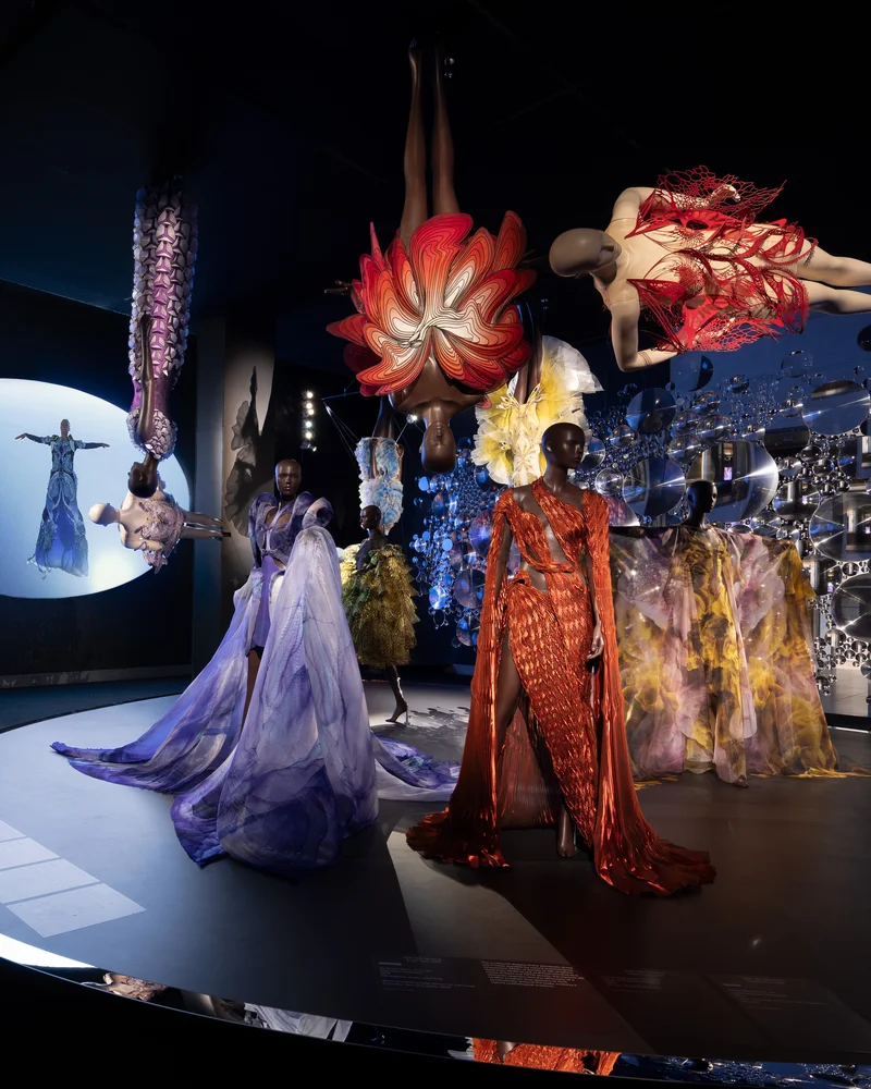 Several dresses on a black platform