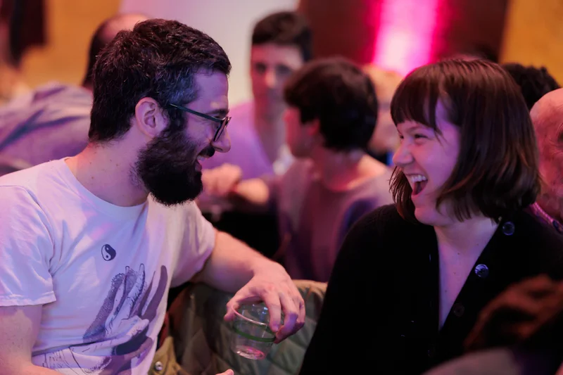 Two people looking at each other and laughing