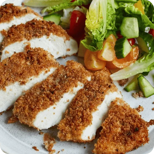 A sliced breaded chicken breast with salad on the side is one of the best chicken breast recipes A sliced breaded chicken breast with salad on the side is one of the best chicken breast recipes
