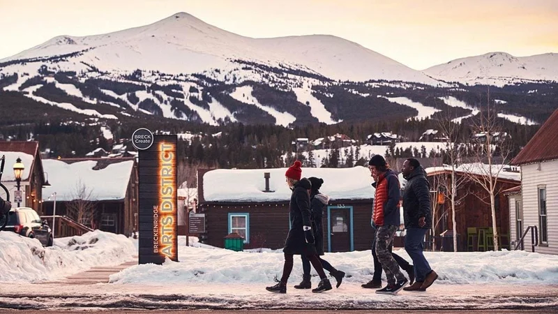 Image description: Group of friends walking in the snow in Breckenridge, Colorado.