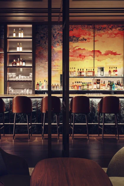 An inviting bar with a vibrant mural in the background.