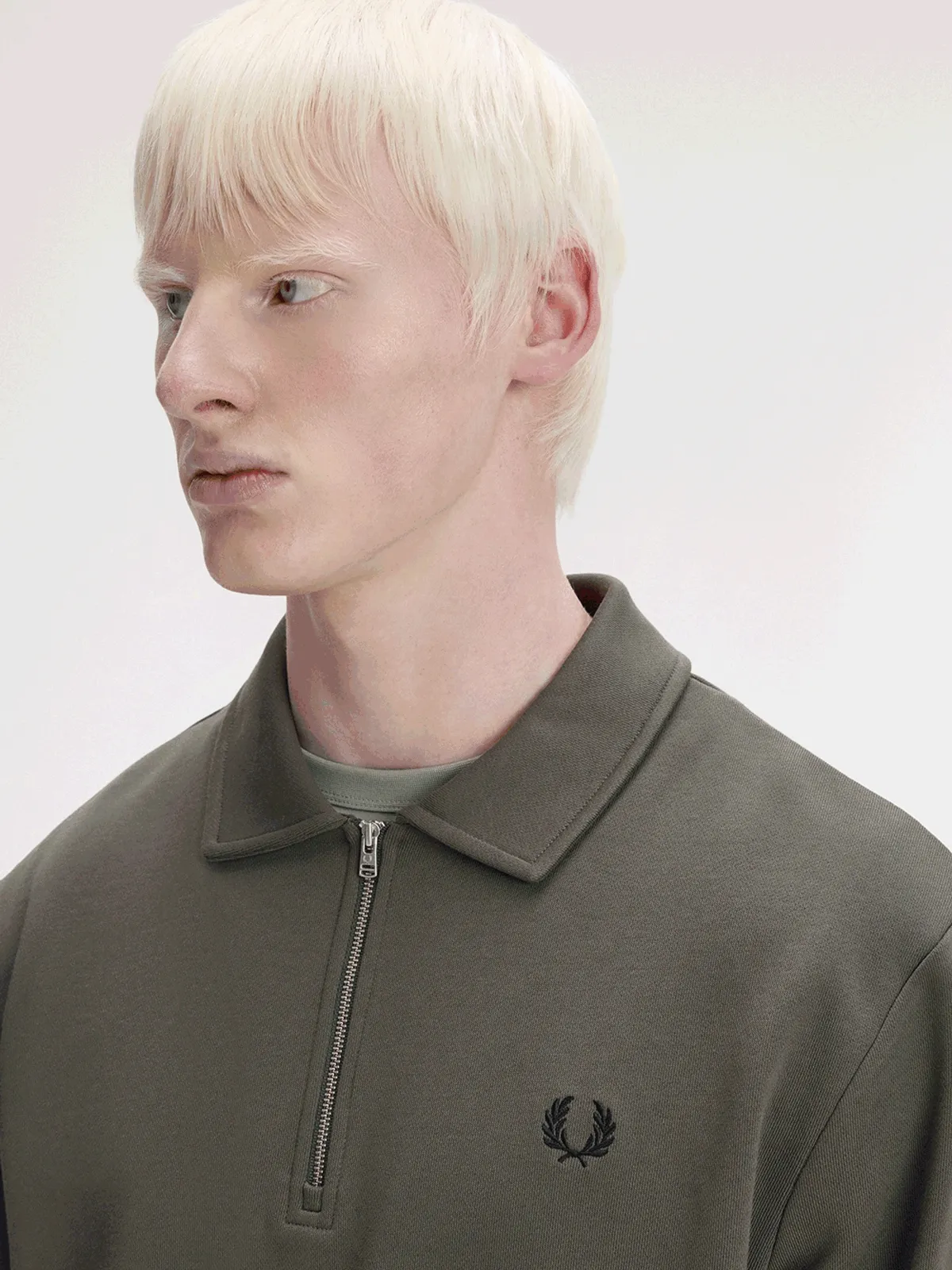 GIF of the collared half zip sweatshirt in its different colourways