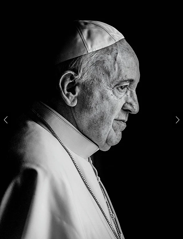 A black and white profile shot of Pope Francis from the shoulders up.