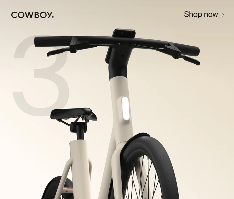 A graphic composition. A render of a Cowbiy Cruiser bike, seen from a low front-on angle, is positioned over the number 10. The Cowboy logo is in the top left and a Shop Now CTA in the top right corner.