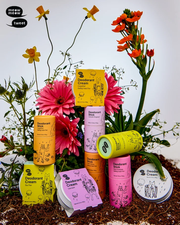 A collection of colorful deodorant sticks are arranged with a collection of flowers