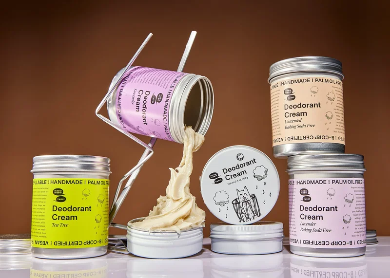 A collection of metal bulk cans refill a tin with creamy frosting-like deodorant