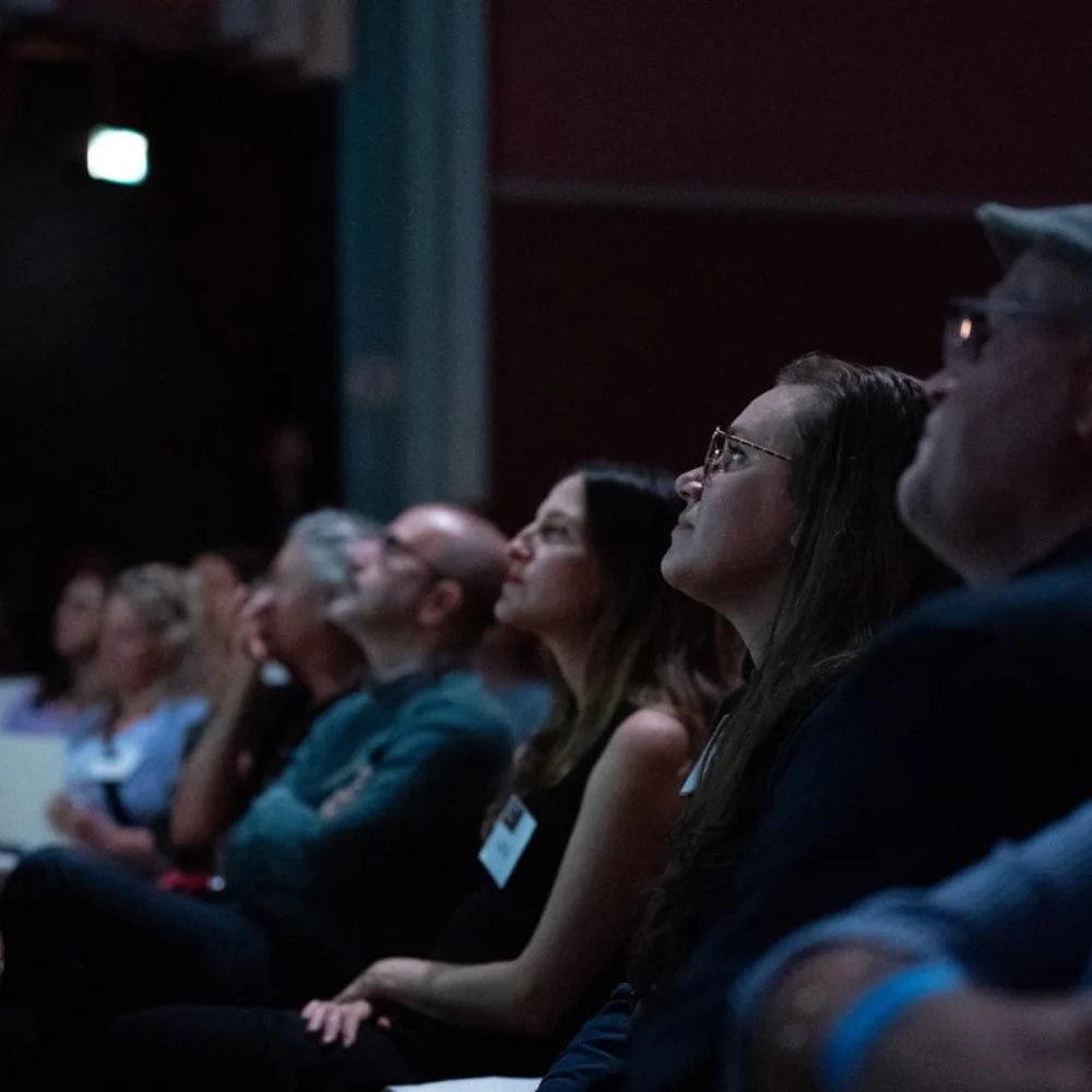 An audience watches a film screening.