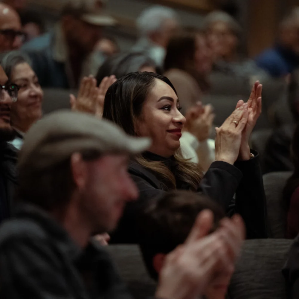 Audience members clap after a screening of "American Pachuco: The Legend of Luis Valdez"