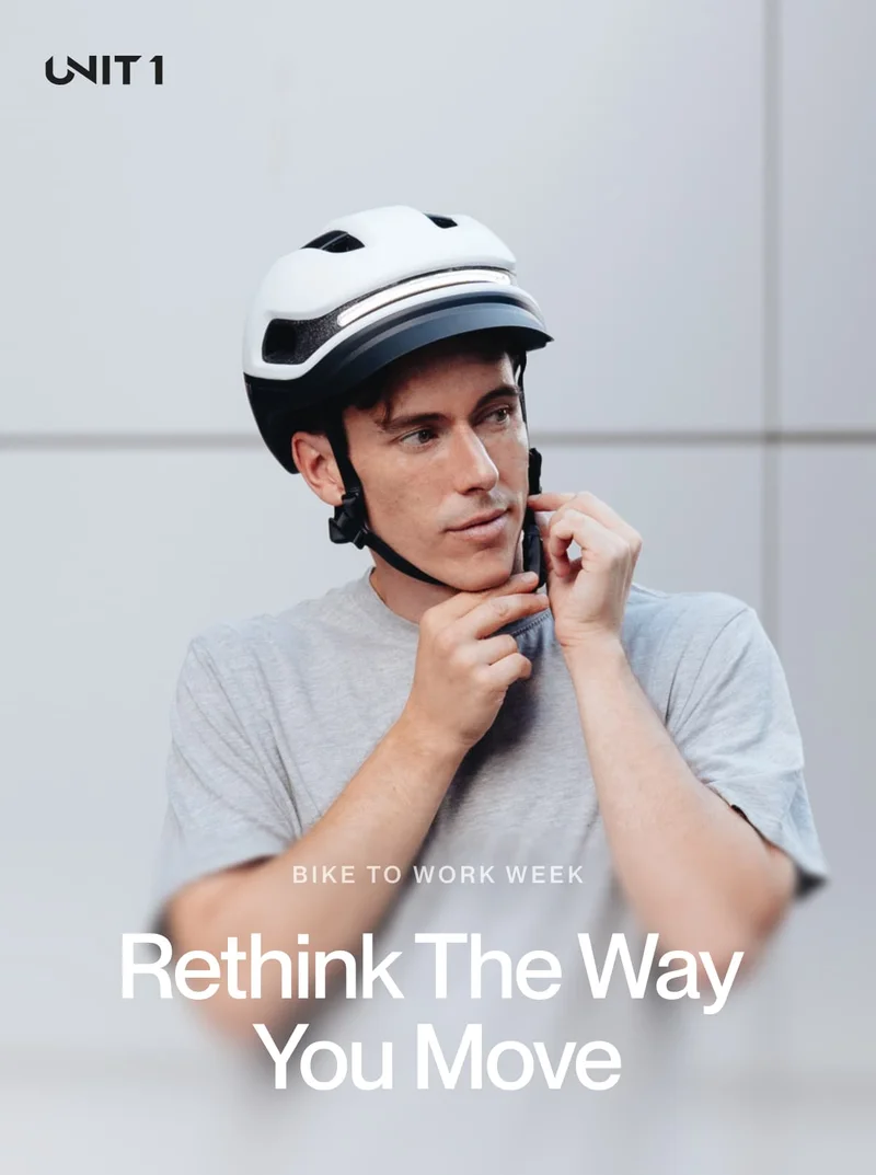 Rider adjusting UNIT 1 smart helmet before commuting by bike during Bike to Work Week