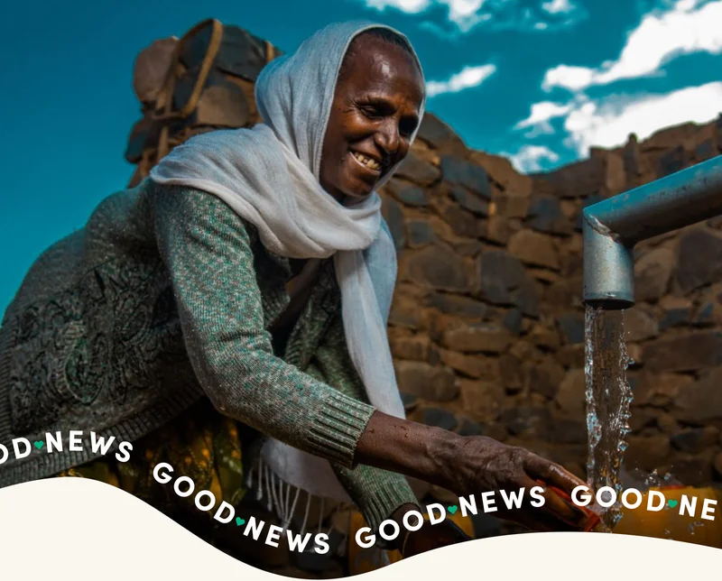 A woman fills up a jerry can with water in Ethiopia.