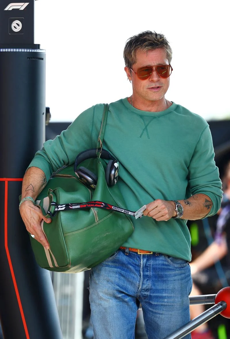 Image may contain: Brad Pitt, Accessories, Bag, Handbag, Wristwatch, Clothing, Pants, Adult, Person, Purse, and Jewelry