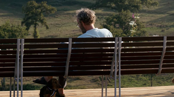 French designer Erwan Bouroullec sitting on a Traverse Lounge Bench.