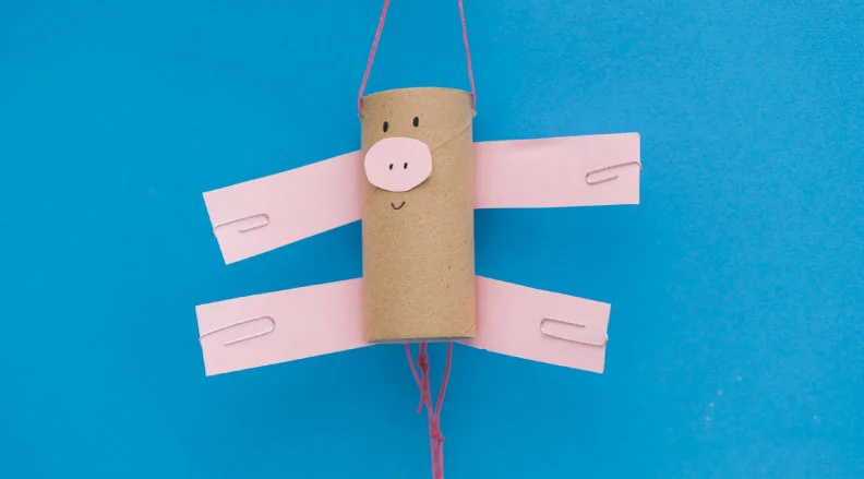 A paper puppet with moveable arms and legs dances using lever mechanisms.