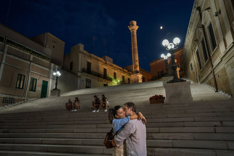 A couple embraces at the Port of Brindisi in Italy.