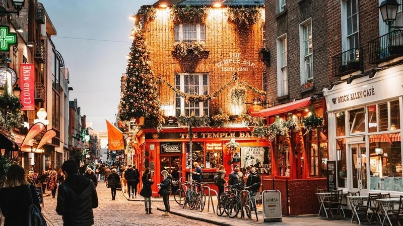 Image description: Street view with vintage brick cafes and walking people.