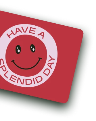 A Splendid Spoon gift card. The card is red, with a smiley face in the middle, surrounded by the text "Have a Splendid Day"
