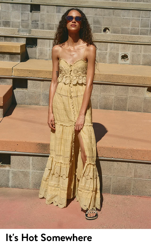 A woman wearing a lace-trim maxi dress.