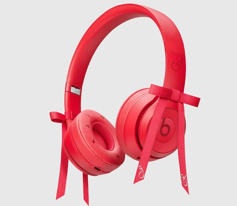 Angled right view of the Beats Solo 4 – JENNIE Special Edition headphones in Ruby Red, with two attachable red bows.