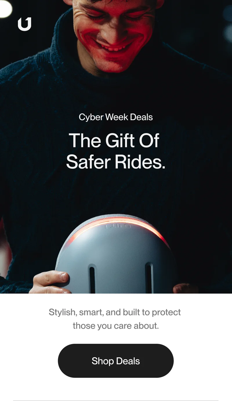 Man holding a smart helmet with integrated lighting, smiling while highlighting the safety and design of the product.