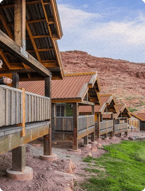 Image Description: A woman admiring the views from her balcony in Moab Springs Ranch