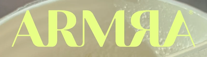 ARMRA logo in bold yellow font over a soft blurred background.