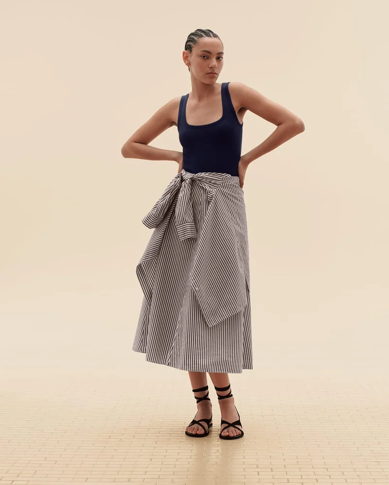 [Editorial Image]Model in The Luxe Rib Racerback Tank | The Boyfriend Shirt in Ultrasoft Cotton | The Midi Skirt in Ultrasoft Cotton | The Leather Criss-Cross Sandal