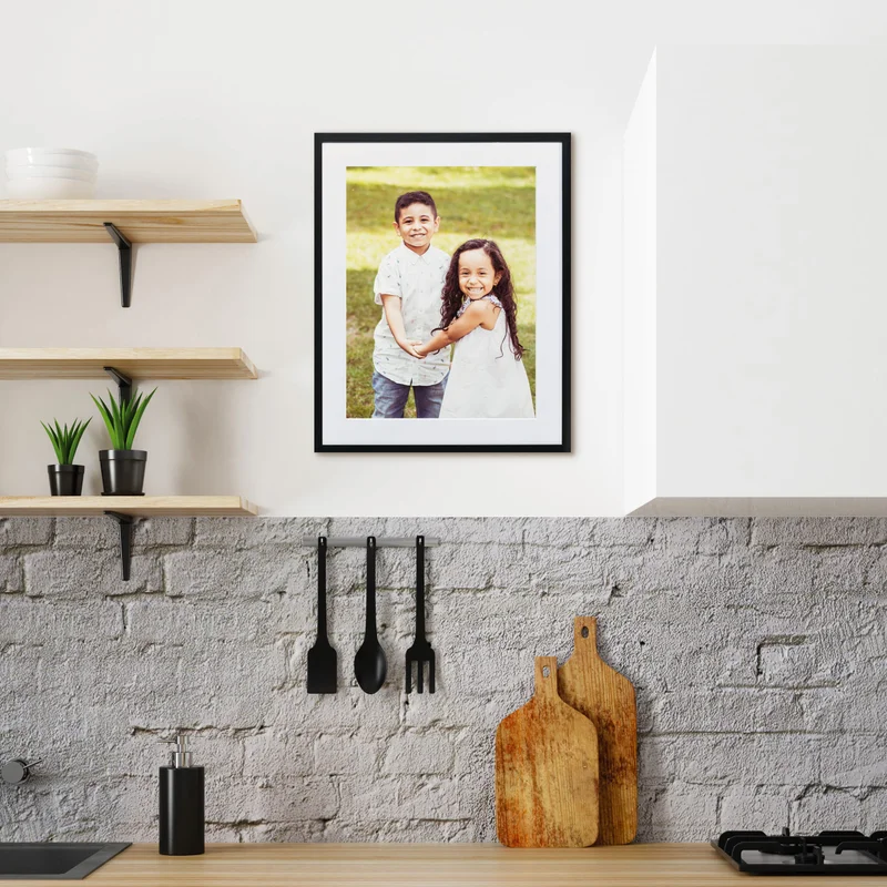 Framed print in kitchen of brother and sister.