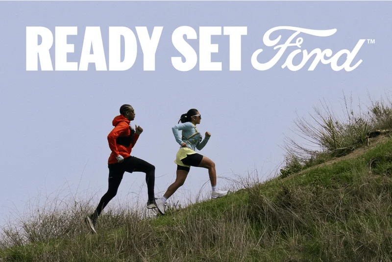 Two people running up a grassy hill with text reading “Ready Set Ford™” above