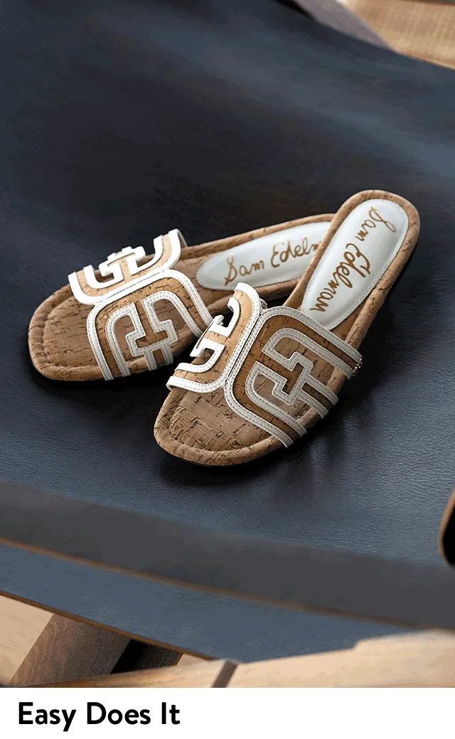 Slides with black and white straps. Slides with cork detail.