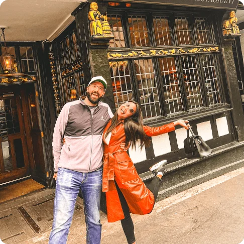Image Description: Man and woman pose informally in front of a pub.