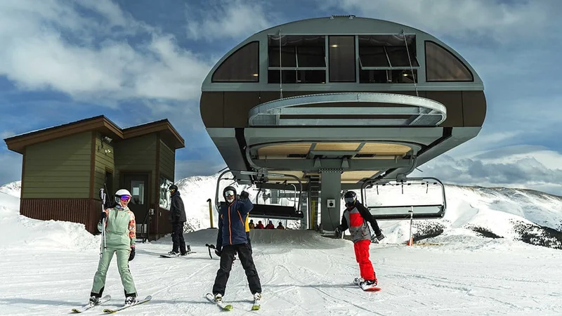 Image description: A group of skiers outside of ski lift on a snowy mountain.