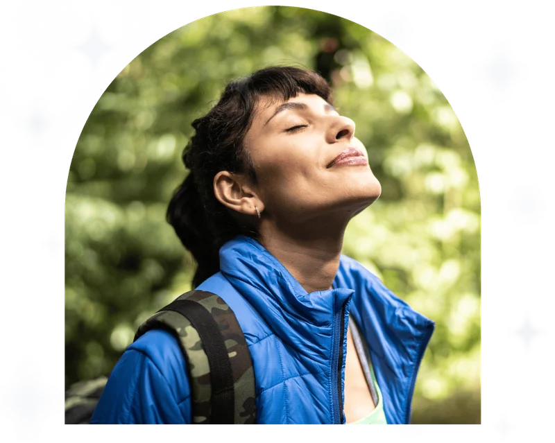 Young woman breathing pure air in a forest