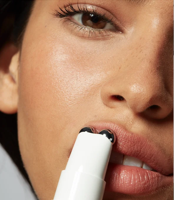Woman using FIX and FIX Serum along lip line for a plumper pout