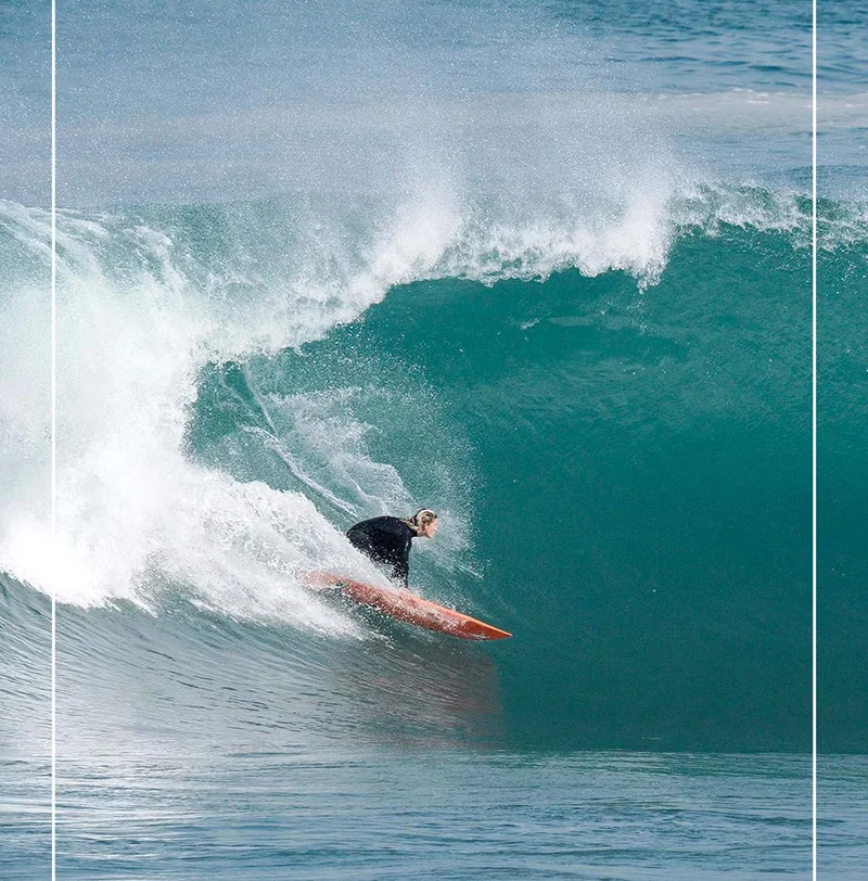 A surfer going left.