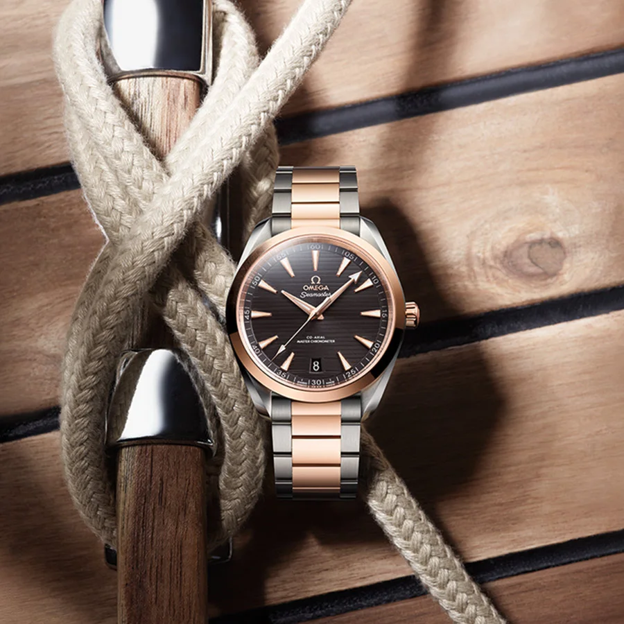 The 41 mm Seamaster Aqua Terra 150M with a grey dial and stainless-steel bracelet, displayed on a wooden surface with nautical ropes, evoking the texture of yacht decks.