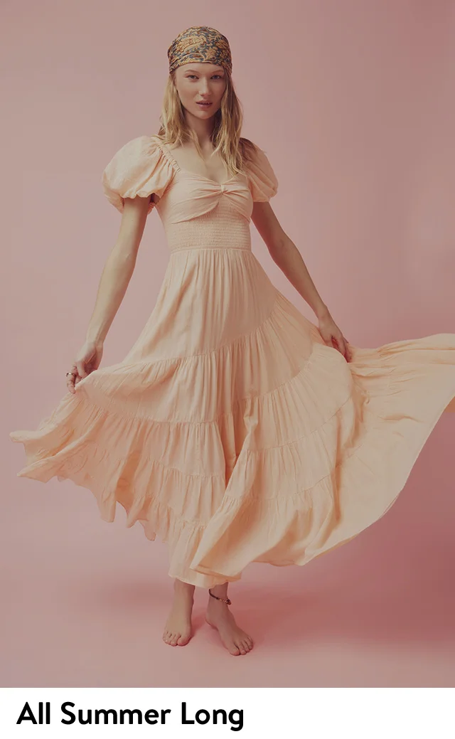 A woman wearing a blush-pink maxi dress.