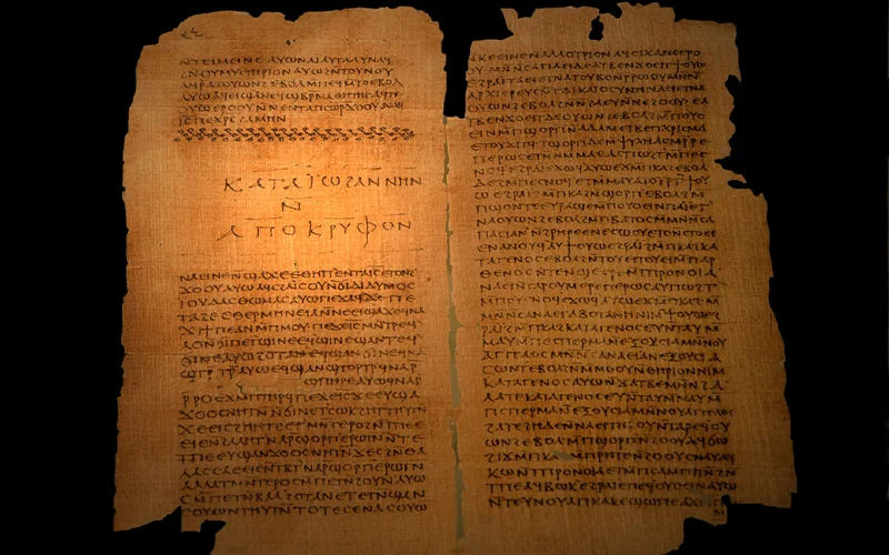 Papyrus manuscript with ancient text on two pages. The scroll has a weathered look, with dark edges