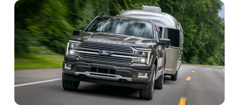 Ford pickup truck towing a camper.