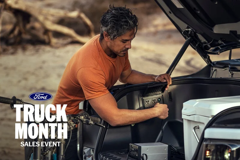 Man using a Pro Power Onboard™ outlet in a truck.