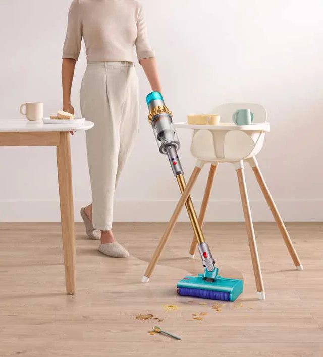 Woman cleaning kitchen area with a Dyson V15s Detect Submarine