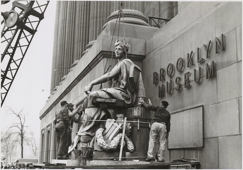Hoisting the statue “Brooklyn” by Daniel Chester French