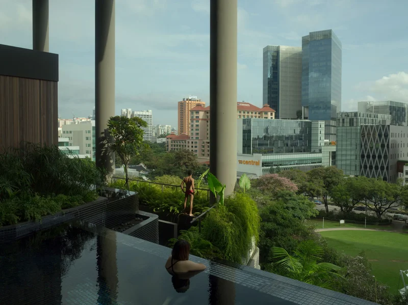 In Singapore, greenery cascades off a luxury hotel, soothing guests in a balcony pool and people on the street below.