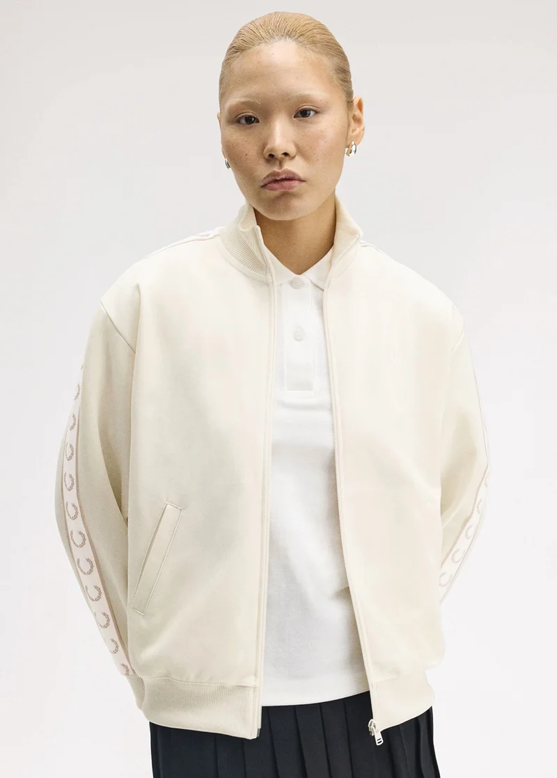 Female model wearing a Taped Track Jacket in Ecru